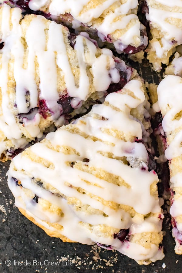 Baked blueberry scones with coconut drizzles on top.