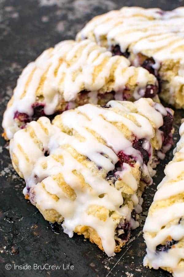 Blueberry Coconut Scones - these soft fluffy scones have juicy blueberries and coconut inside them. The coconut glaze on top adds a delicious tropical taste. Make this recipe for breakfast or brunch this summer. #breakfast #scones #blueberry #coconut #pastries #homemade #recipe #easy