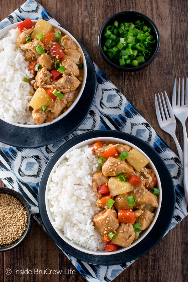 Overhead picture of two white bowls filled with rice and sweet and sour chicken