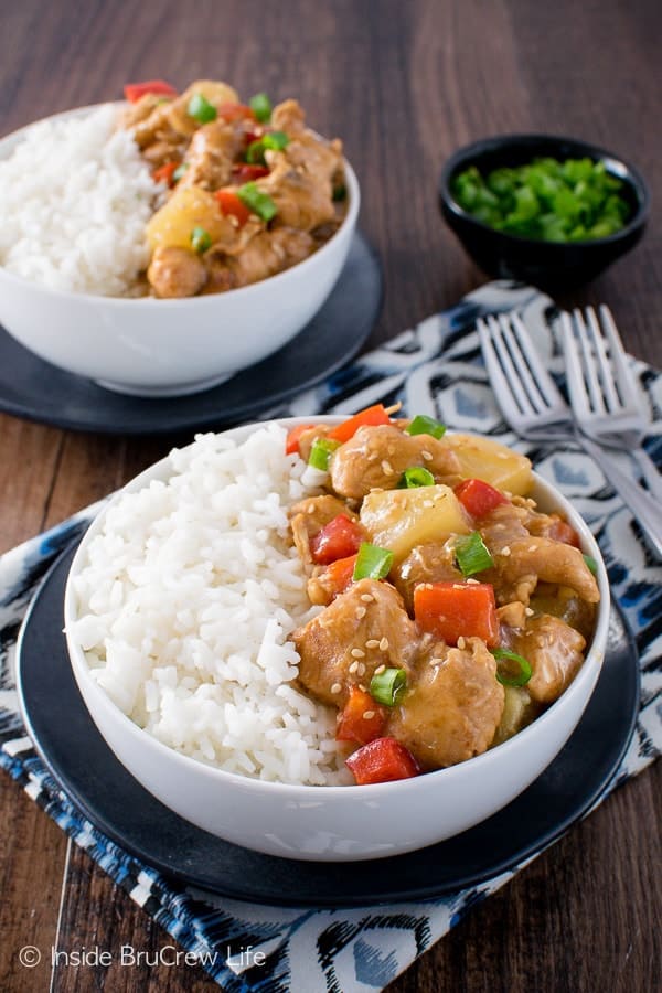 Two bowls filled with rice and sweet and sour crockpot chicken