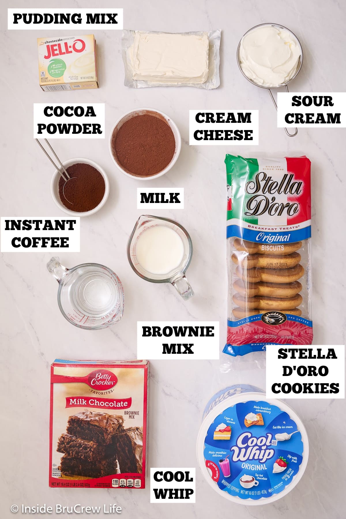 A white board with bowls of ingredients needed to make an easy brownie dessert.