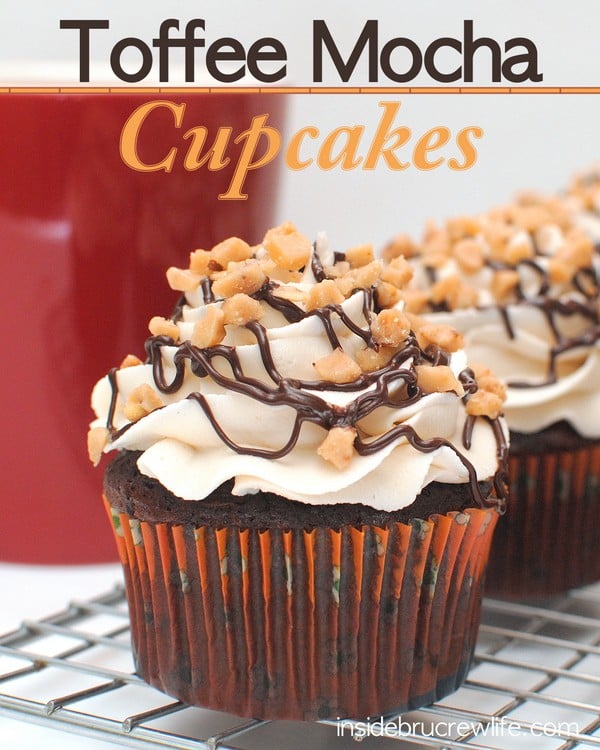 A close up picture of Toffee Mocha Cupcakes with chocolate drizzles and toffee bits