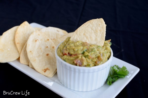 Guacamole Hummus with Football Chips - homemade football shaped chips are perfect for digging into this chunky dip. Great recipe for game day parties!