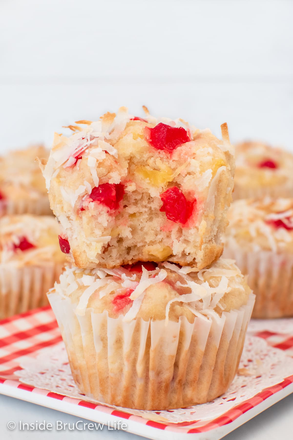 Two stacked banana muffins on a tray.