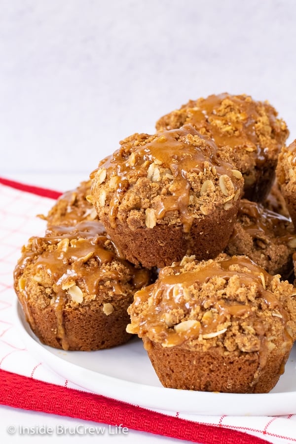 A white plate with apple biscoff muffins stacked on it