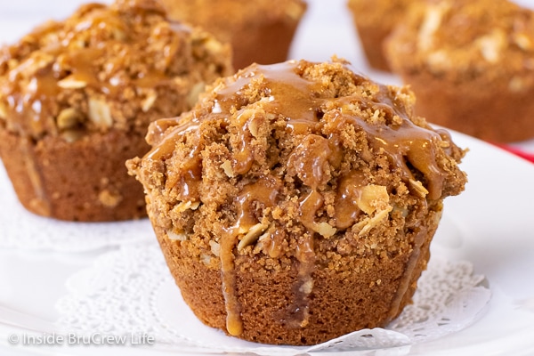 A close up picture of a Biscoff Apple Muffin with cookie butter drizzles on top