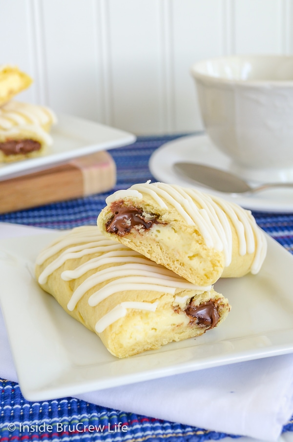 A crescent roll filled with cream cheese and Nutella on a white plate.