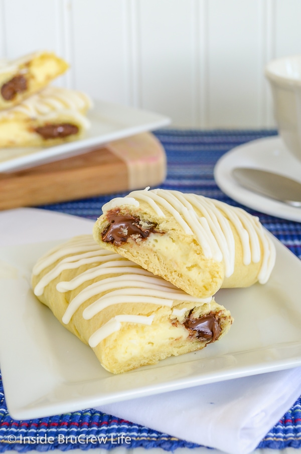 A cheesecake nutella twist cut in half and stacked on a white plate.