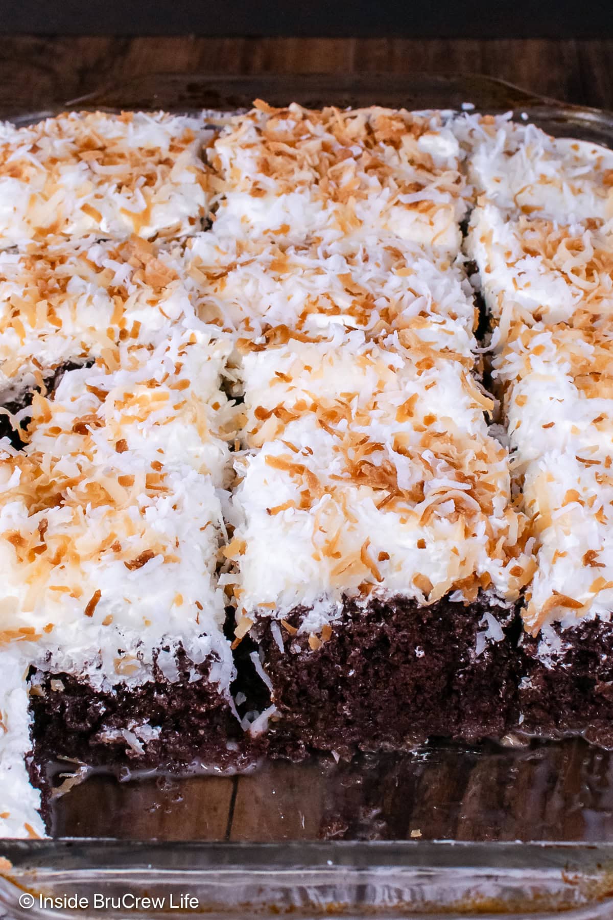 A cake pan filled with a chocolate coconut poke cake.