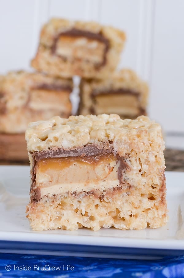 Candy Bar Stuffed Rice Krispie Treats - a hidden candy bar center takes these easy no bake treats over the top. Awesome recipe to use up extra candy bars!