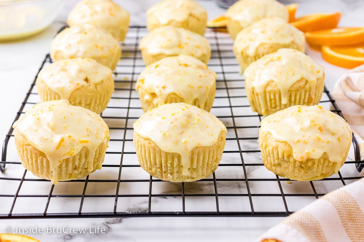 Glazed muffins on a wire rack.