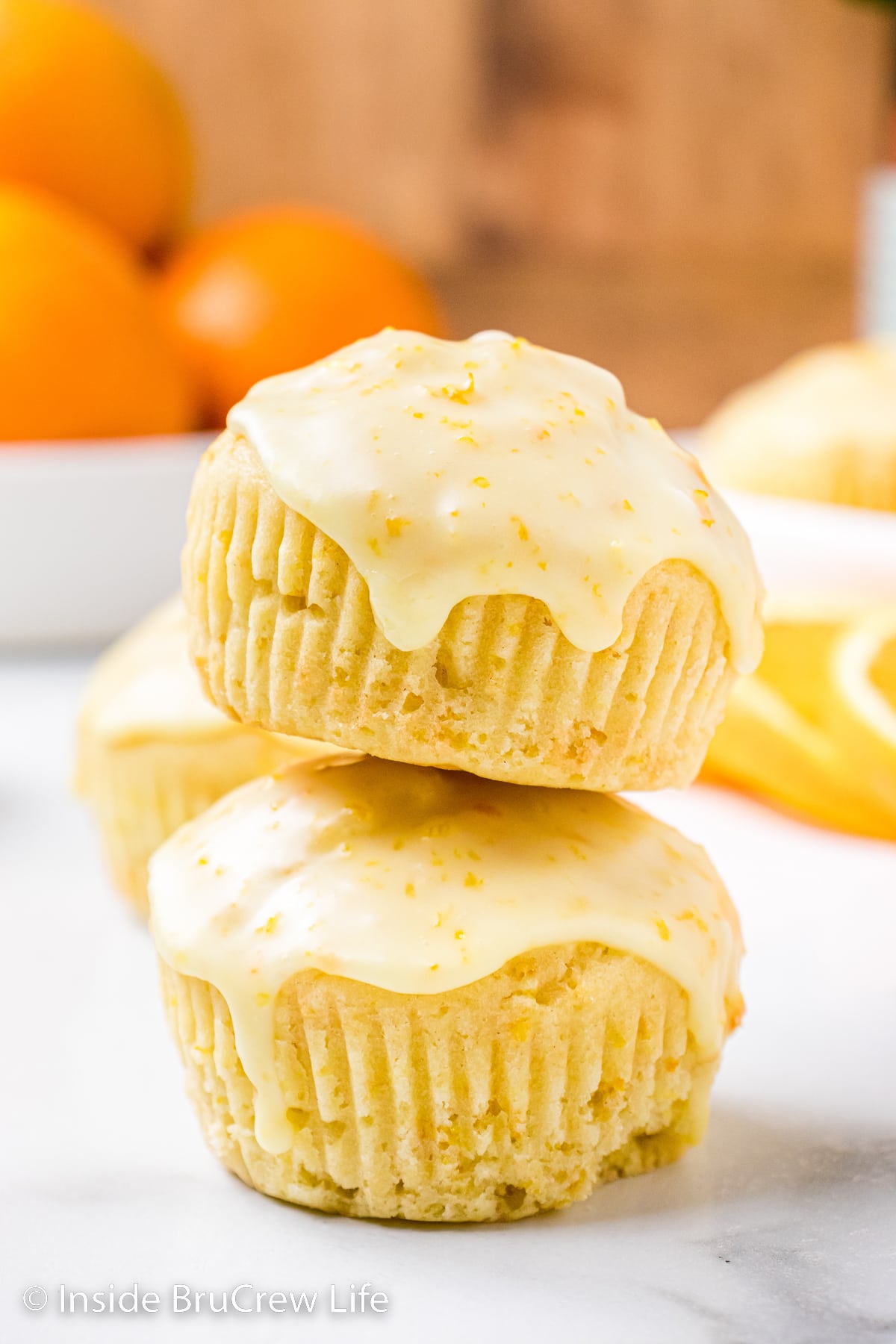 Two orange muffins stacked on top of each other.