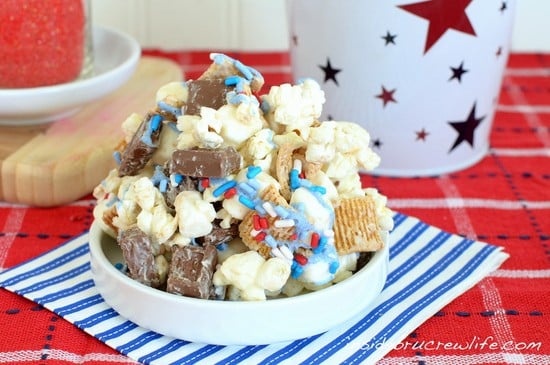 A white dish on a red towel filled with S'mores Popcorn