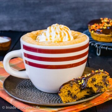 A white mug filled with salted caramel pumpkin latte and topped with whipped cream and caramel
