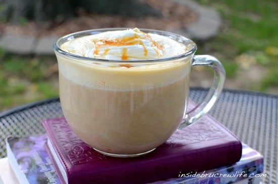 A clear mug filled with Salted Caramel Pumpkin Latte and topped with whipped cream