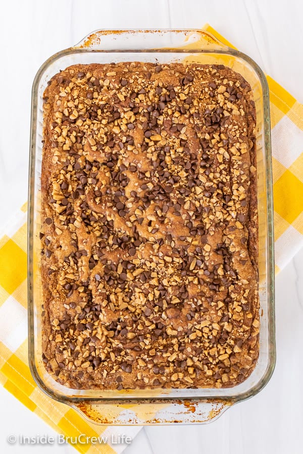 Overhead picture of a banana toffee cake in a glass baking dish on a white background