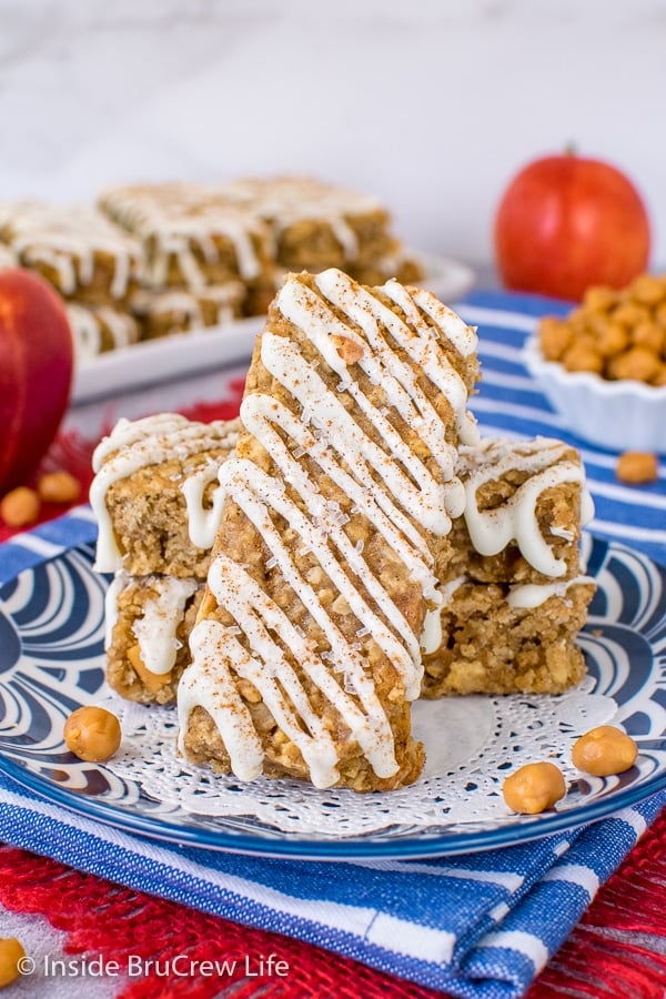 A plate with homemade apple granola bars on it with one standing up.