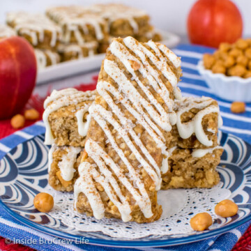 A blue plate with three caramel apple granola bars stacked on it
