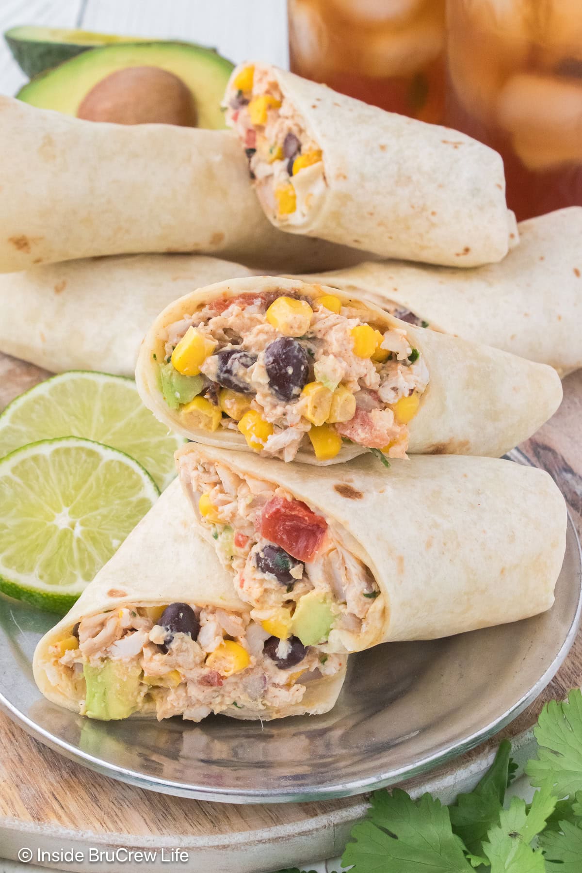 Mexican chicken salad wraps stacked on a plate.