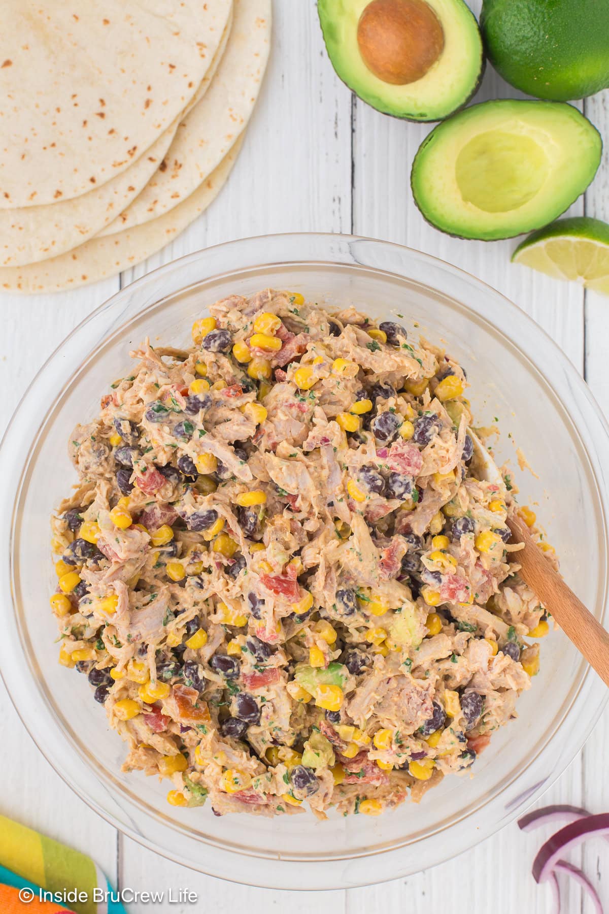 A clear bowl filled with a Mexican chicken salad recipe.