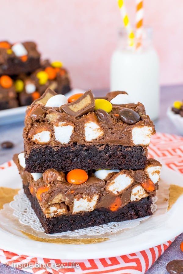 Two Reese's Fluffernutter Fudge Brownies stacked on top of each other on a white plate