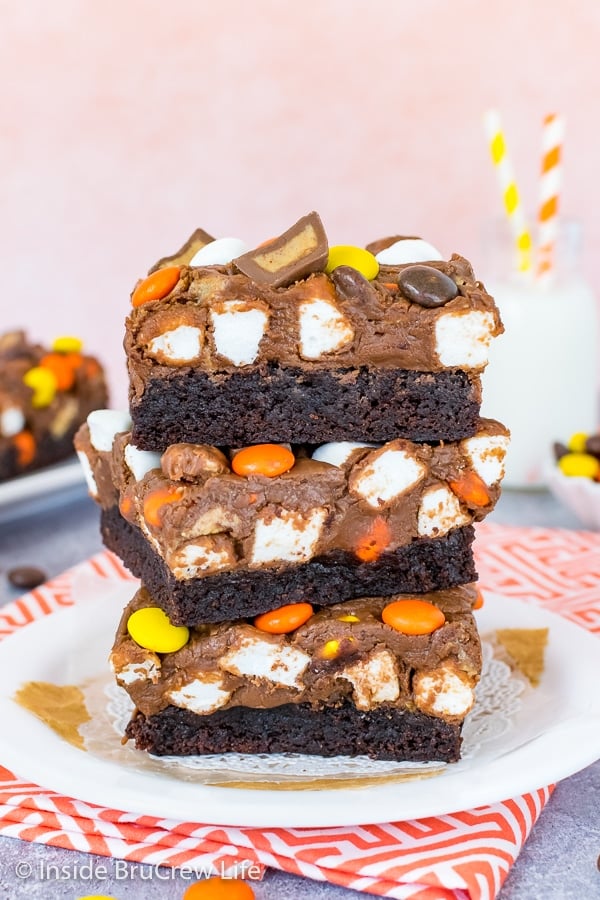 A white plate with three Reese's Fluffernutter Fudge Brownies stacked on top of each other