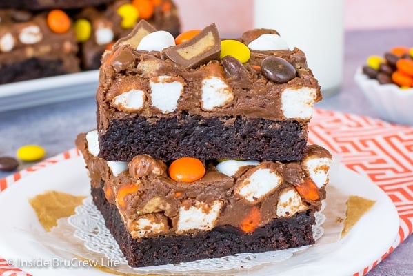 A white plate with two Reese's fluffernutter fudge brownies stacked on top of each other