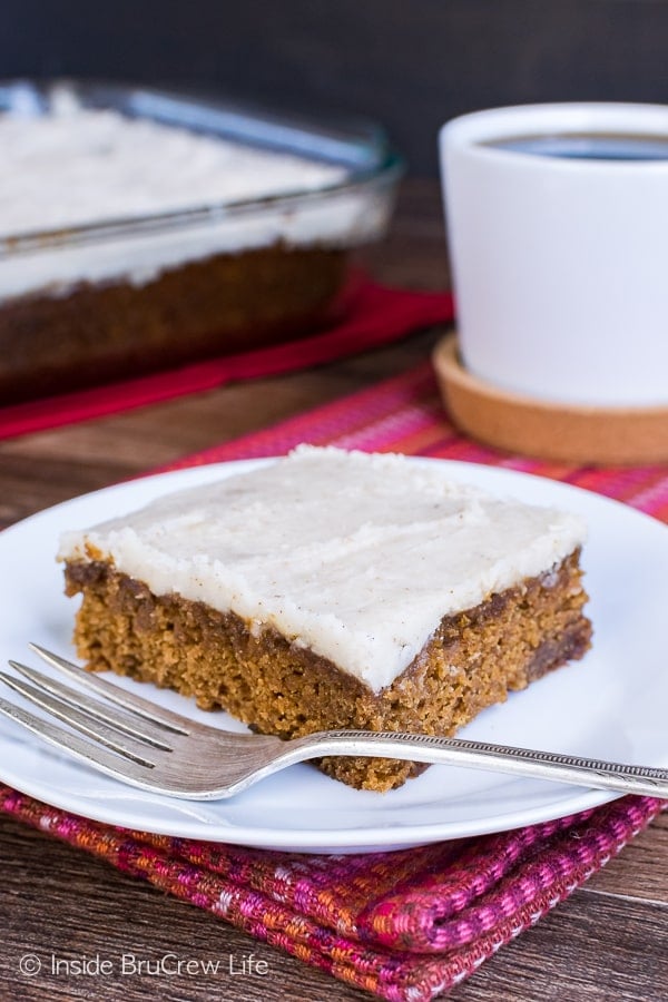 A square of apple butter cake topped with vanilla bean glaze on it.