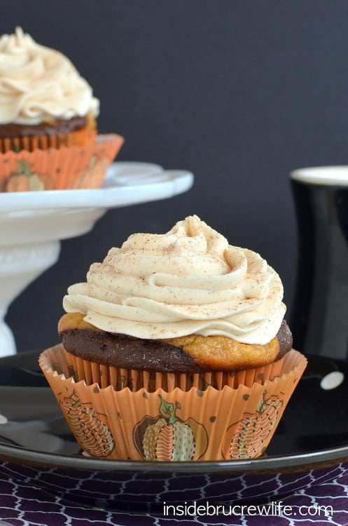 These chocolate cupcakes with a pumpkin cheesecake center and white chocolate cinnamon frosting are perfect for any fall party.