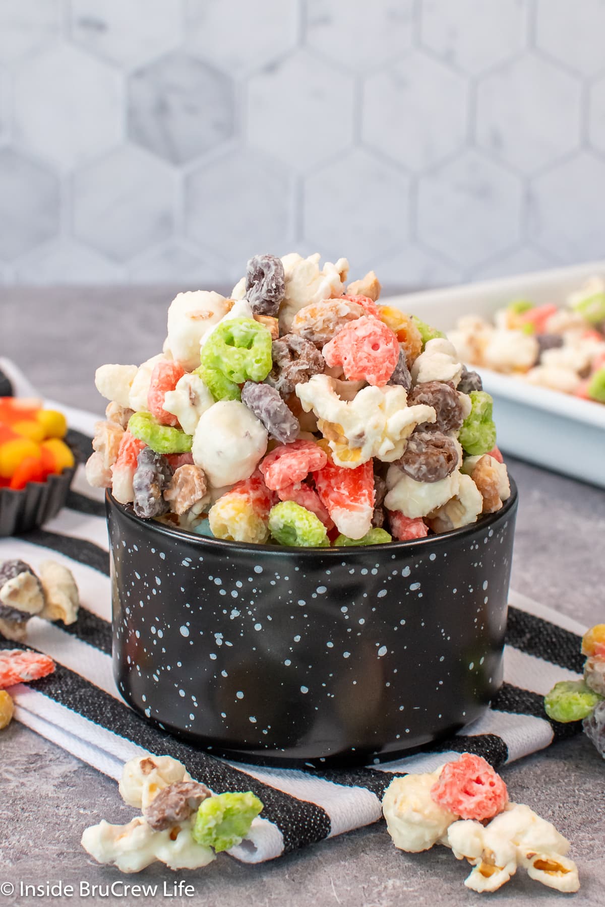 A black bowl filled with chocolate covered popcorn.