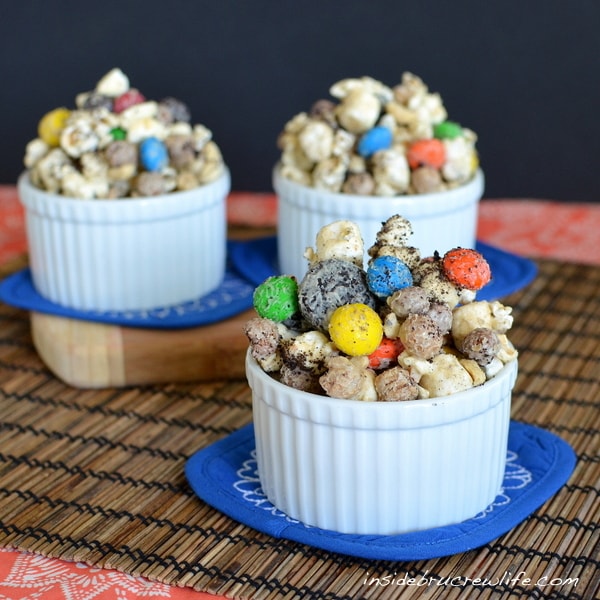 White Chocolate and peanut butter covered popcorn with Oreo cookies and M&M candies is a great movie night snack.
