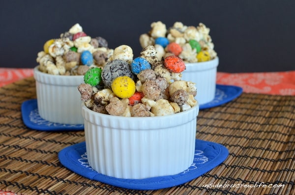 White Chocolate and peanut butter covered popcorn with Oreo cookies and M&M candies is a great movie night snack.