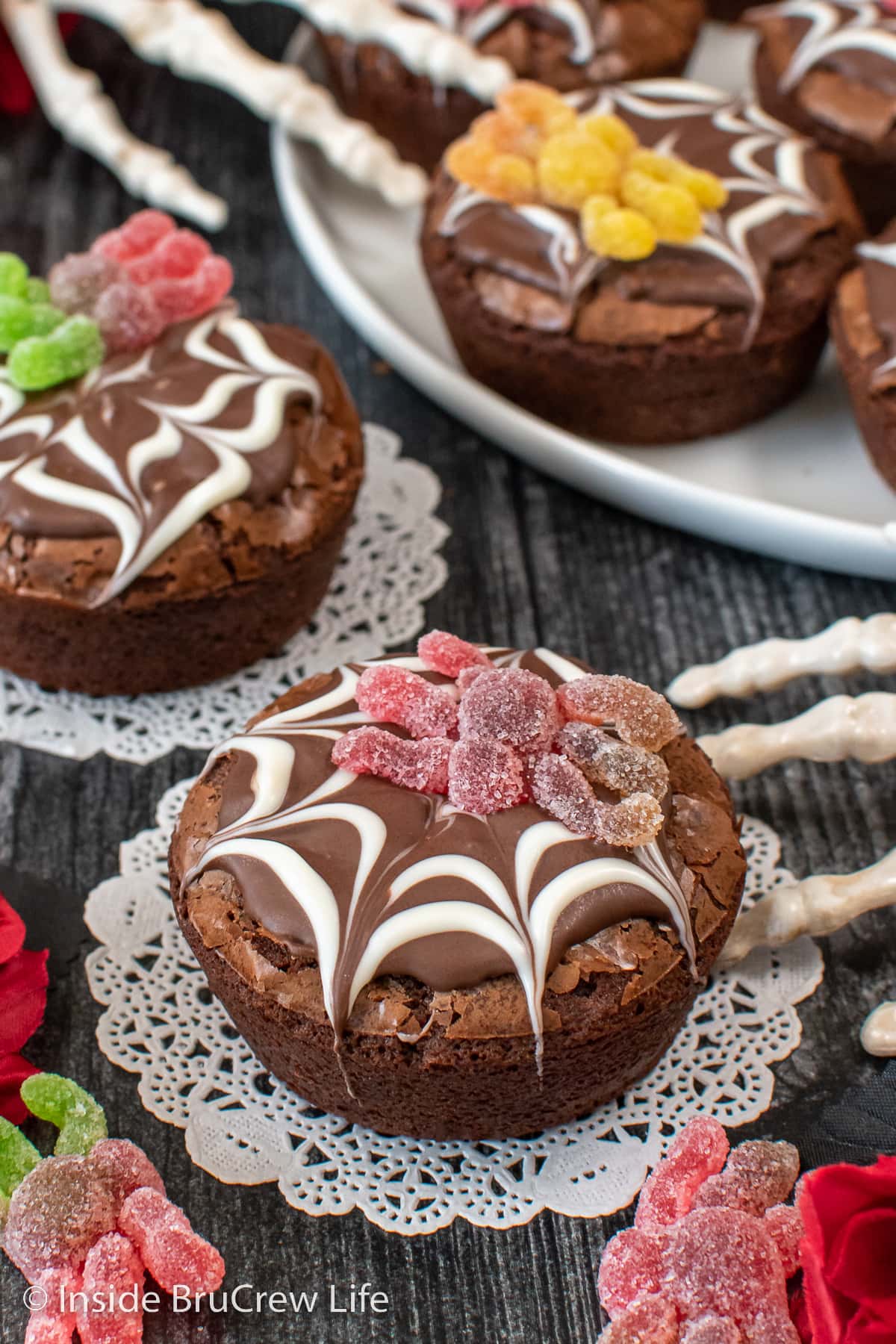 Cupcake brownies topped with chocolate spider webs and spider gummies.