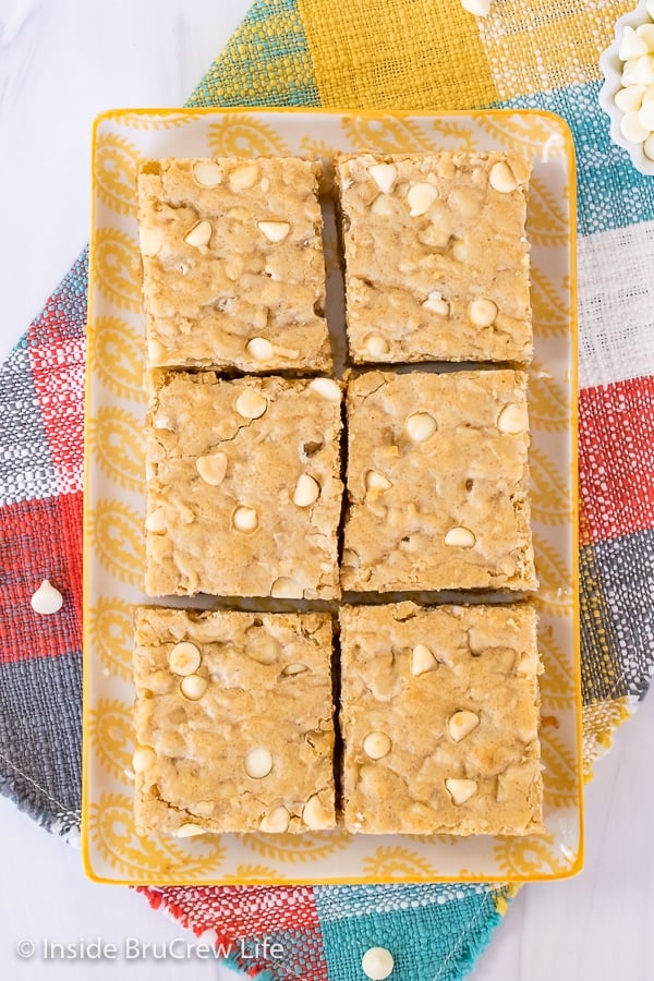 Overhead picture of a plate with six squares of tropical blonde brownies