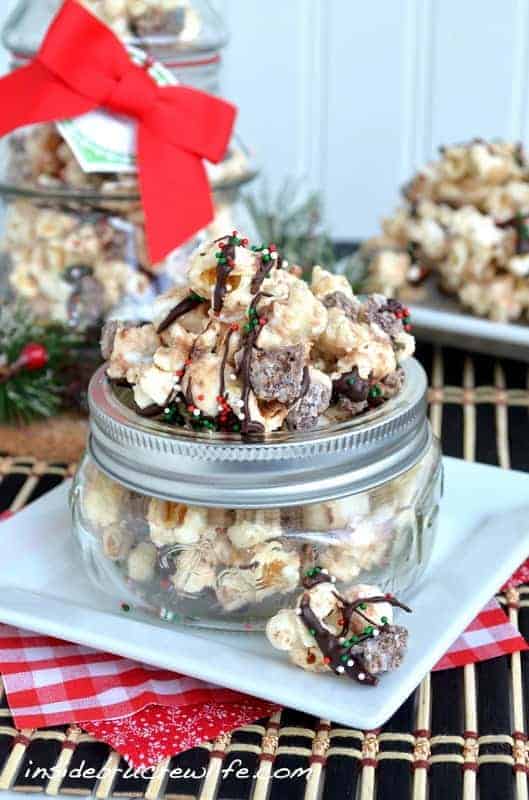 Banana Crunch Popcorn - this easy chocolate covered popcorn has a banana flavor and is loaded with candy bars! Great snack mix recipe!