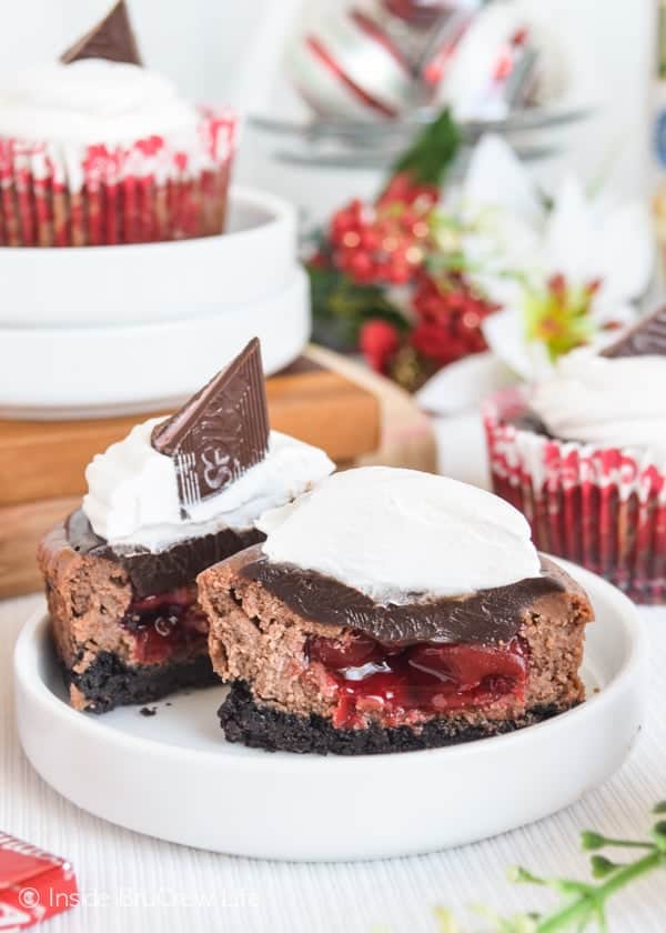 Cherry Chocolate Cheesecakes cut in half on a small white plate.