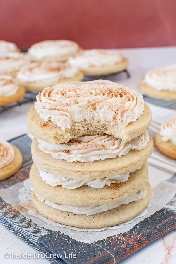 A stack of four cinnamon sugar cookies on a towel.