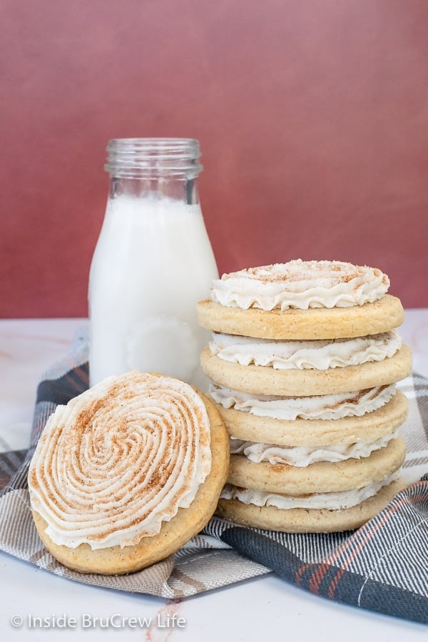 A stack of five churro cookies and a bottle of milk with another cookie leaning against them.