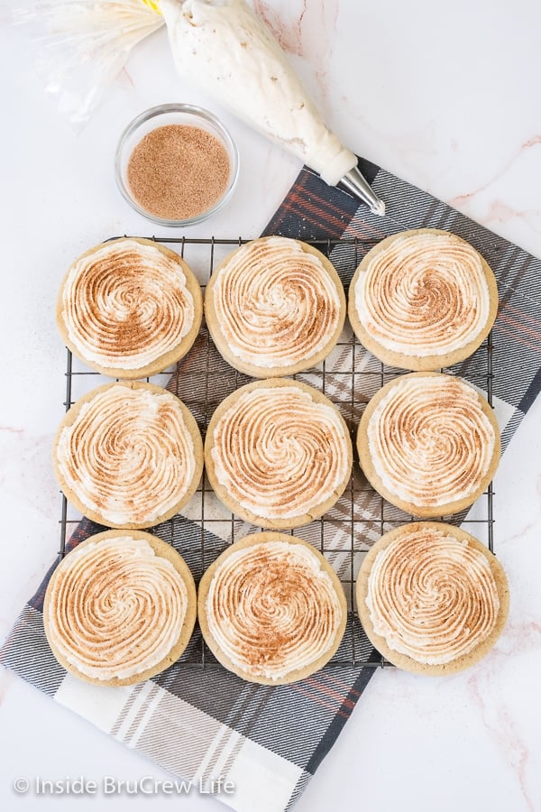 Overhead picture of a wire rack with frosted churro cookies on it.