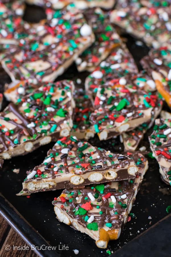 A bunch of pieces of Salted Caramel Pretzel Bark broken up on a sheet pan.