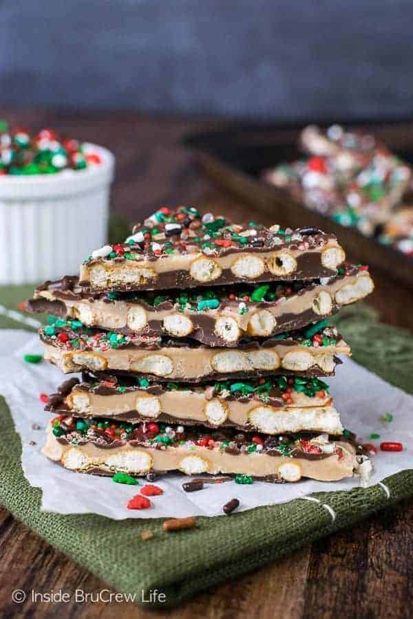 A stack of Salted Caramel Pretzel Bark with a pan and sprinkles in the background.