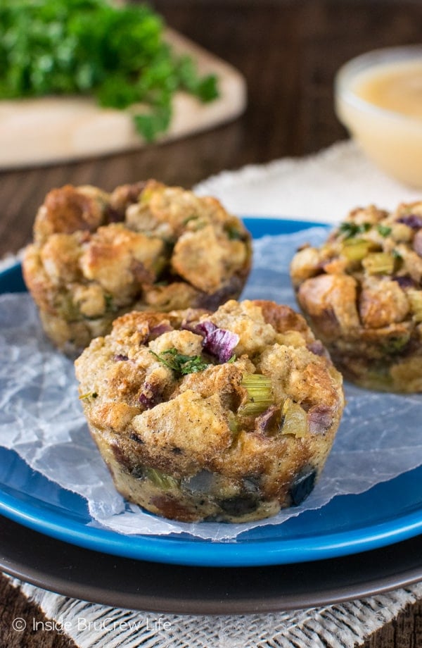 A blue plate with three stuffing muffins on it