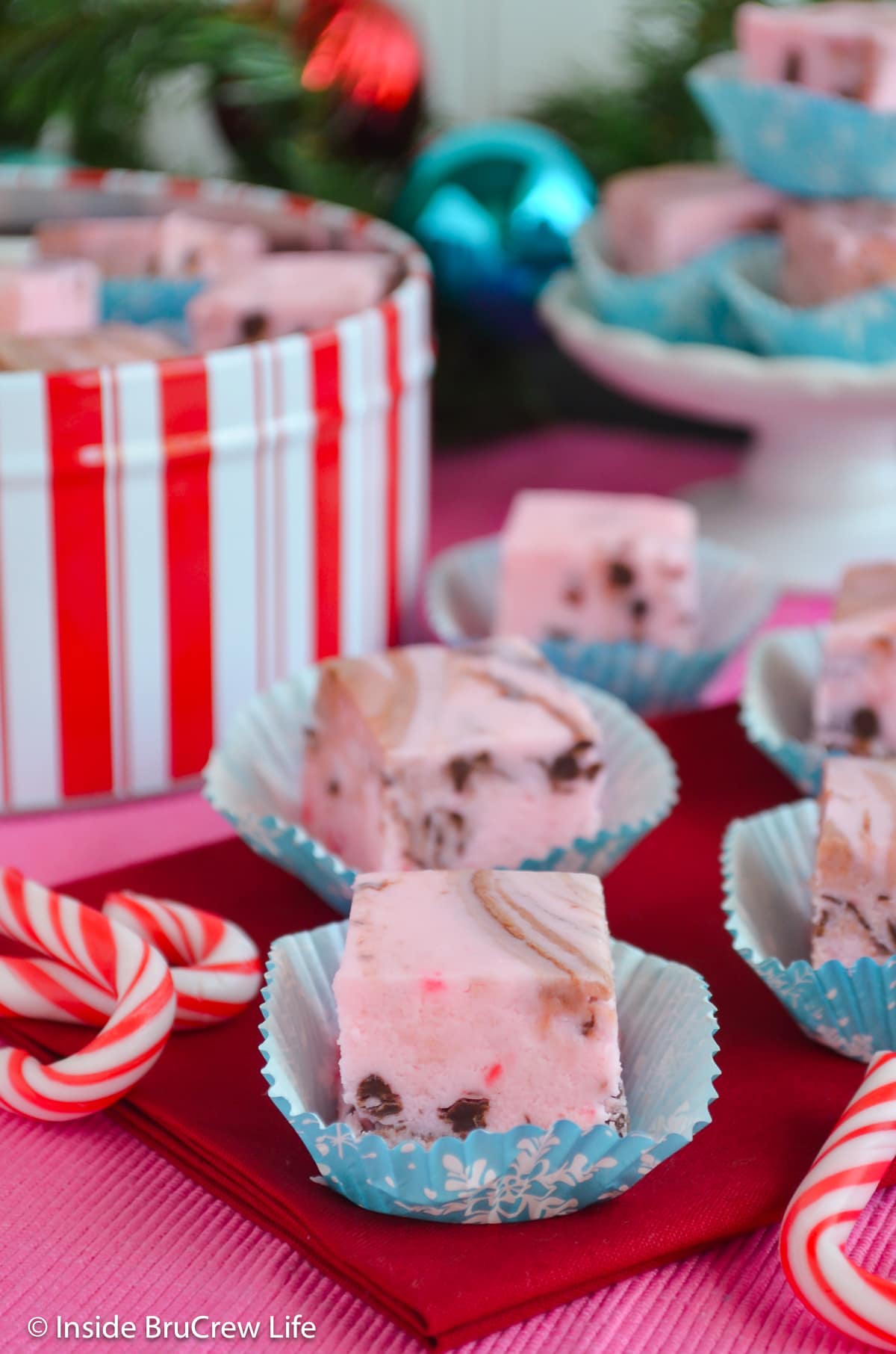 Pink peppermint fudge on a red towel.