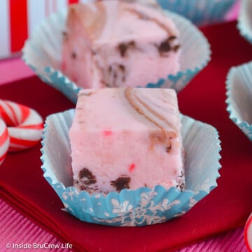 A square of pink candy cane fudge with chocolate swirls.