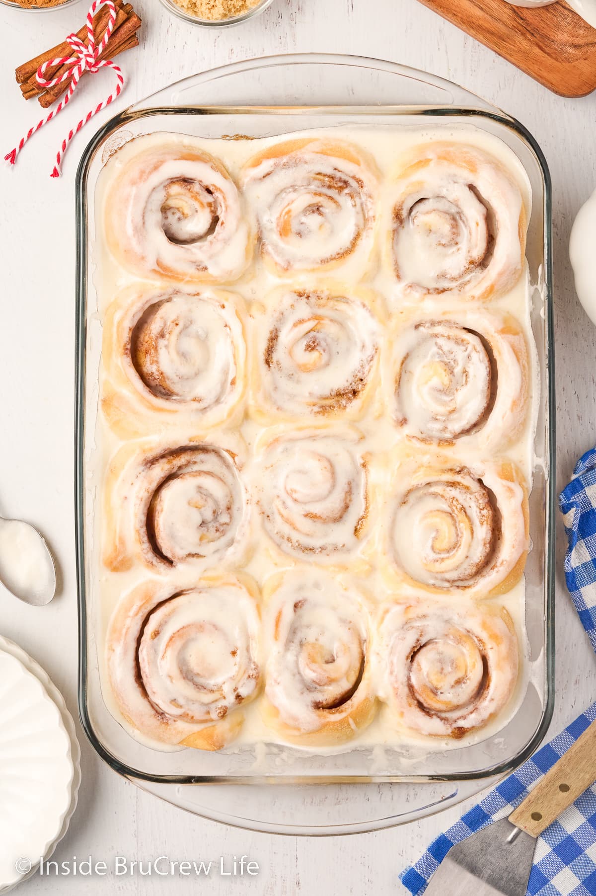 A baking dish filled with frosted cinnamon rolls.