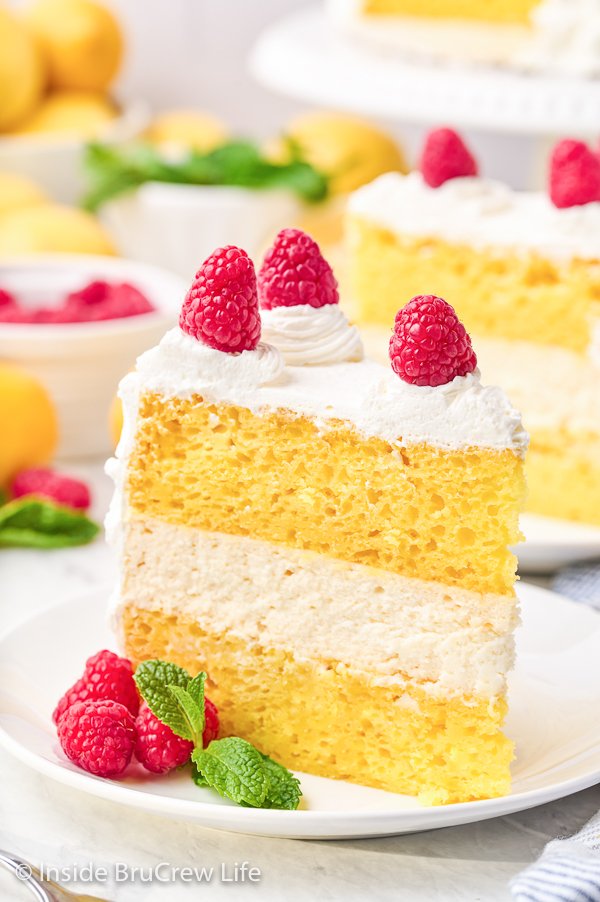 A lemon cheesecake cake slice on a white plate.