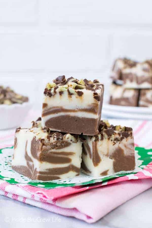 3 pieces of Mint Brownie Swirl Fudge on a green doily and a pink towel.