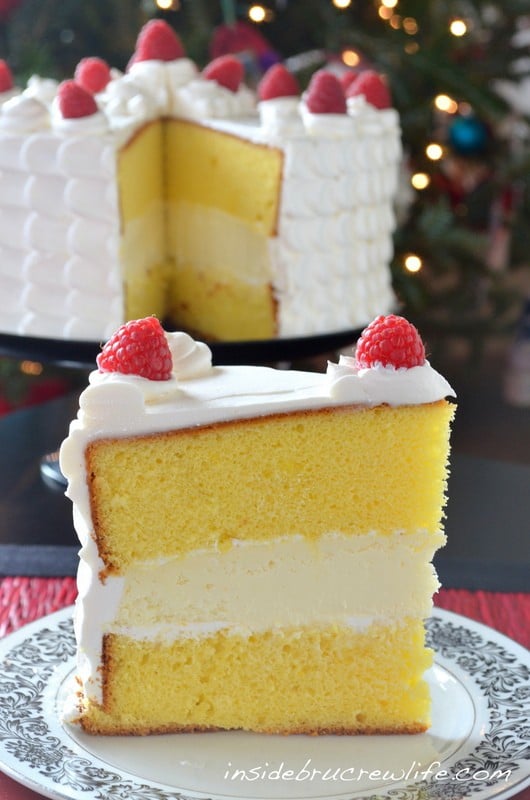Lemon cake layers filled with a vanilla cheesecake makes an impressive holiday cake.
