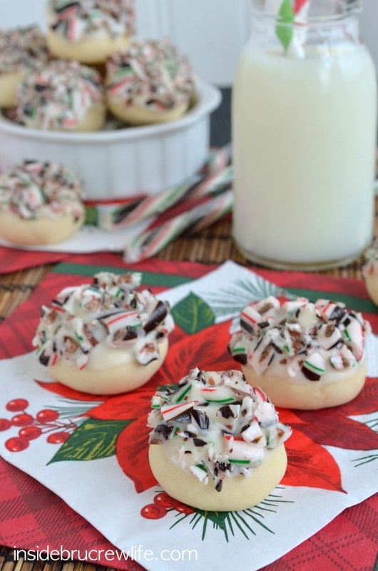 close up shot of three cookies dipped in white chocolate and sprinkled with candy canes