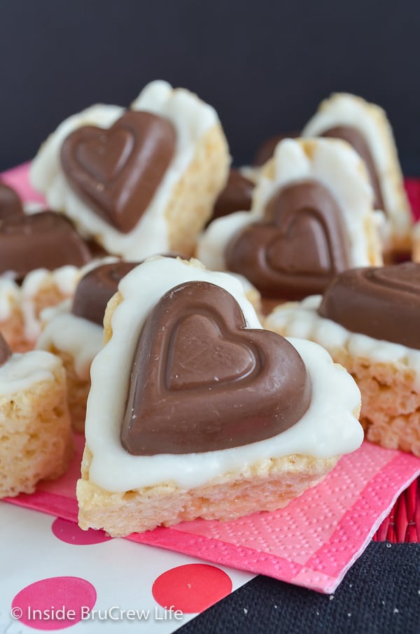 A heart shaped rice krispie treat with a Reese's peanut butter shaped heart on it.
